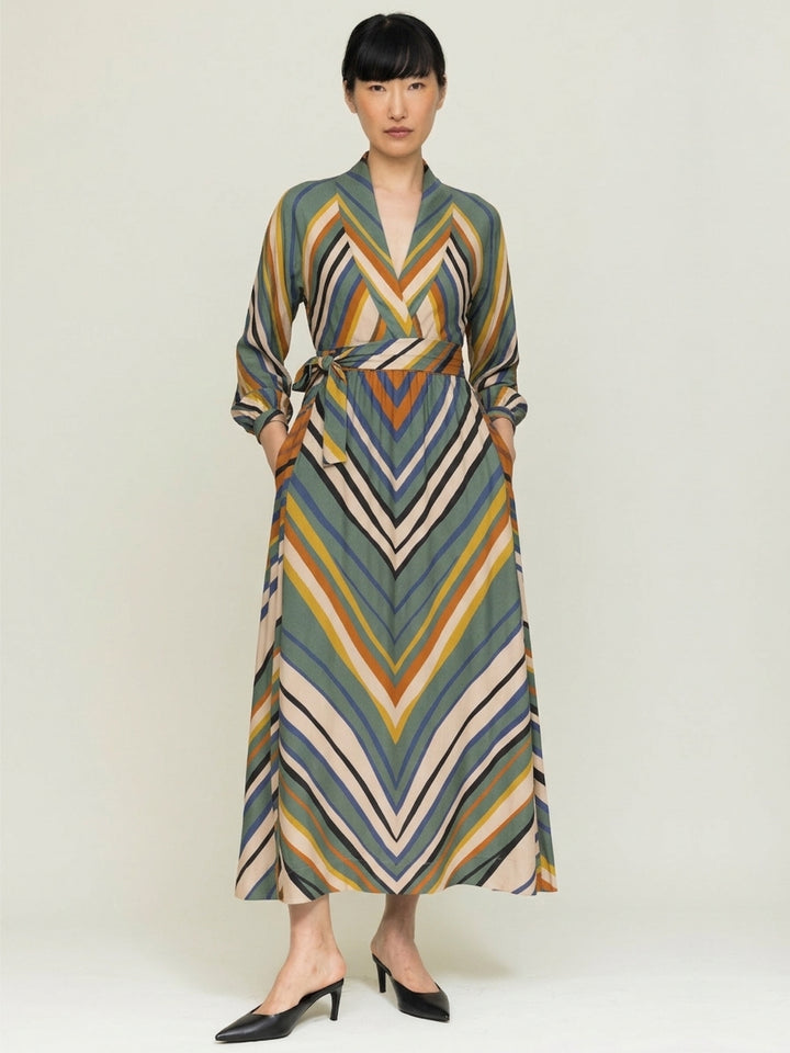 model wearing stripe print wrap dress n neutral backgroud front view 